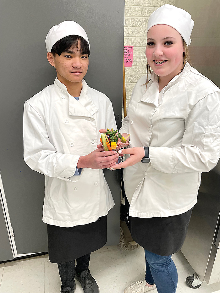 Kennedi and Charlton of McNaughton High School share one of the healthy breakfast recipes that their Home Ec. class makes for their breakfast program at the school.